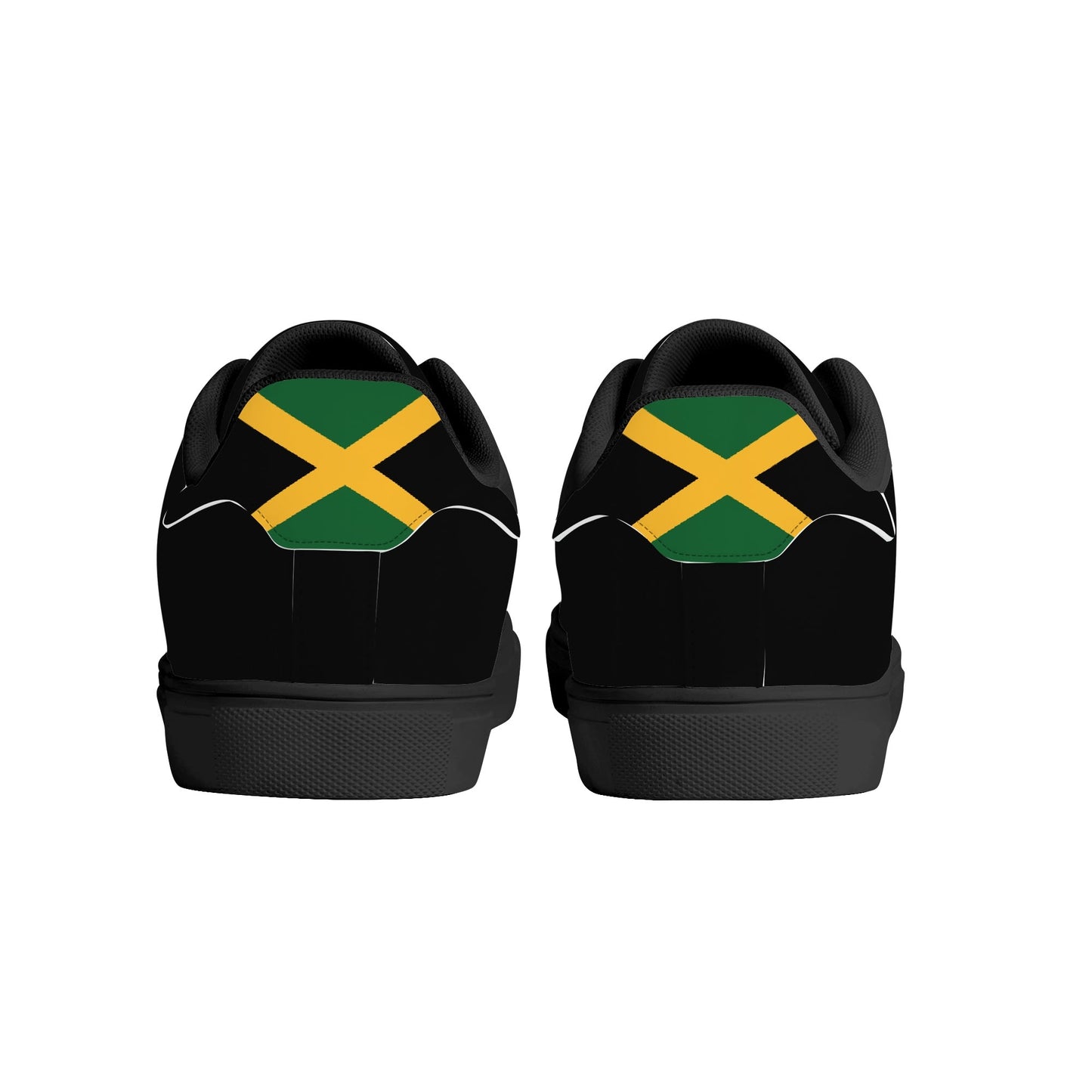 All-black Jamaica flag Ackee Walkers low top sneakers with black laces, black outsole and a green and gold Jamaican flag chevron at the heel