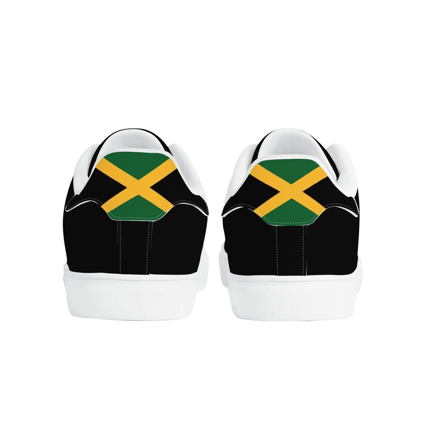 All-black Jamaica flag Ackee Walkers low top sneakers with black laces, black outsole and a green and gold Jamaican flag chevron at the heel