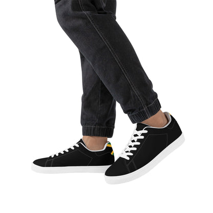 All-black Jamaica flag Ackee Walkers low top sneakers with black laces, black outsole and a green and gold Jamaican flag chevron at the heel