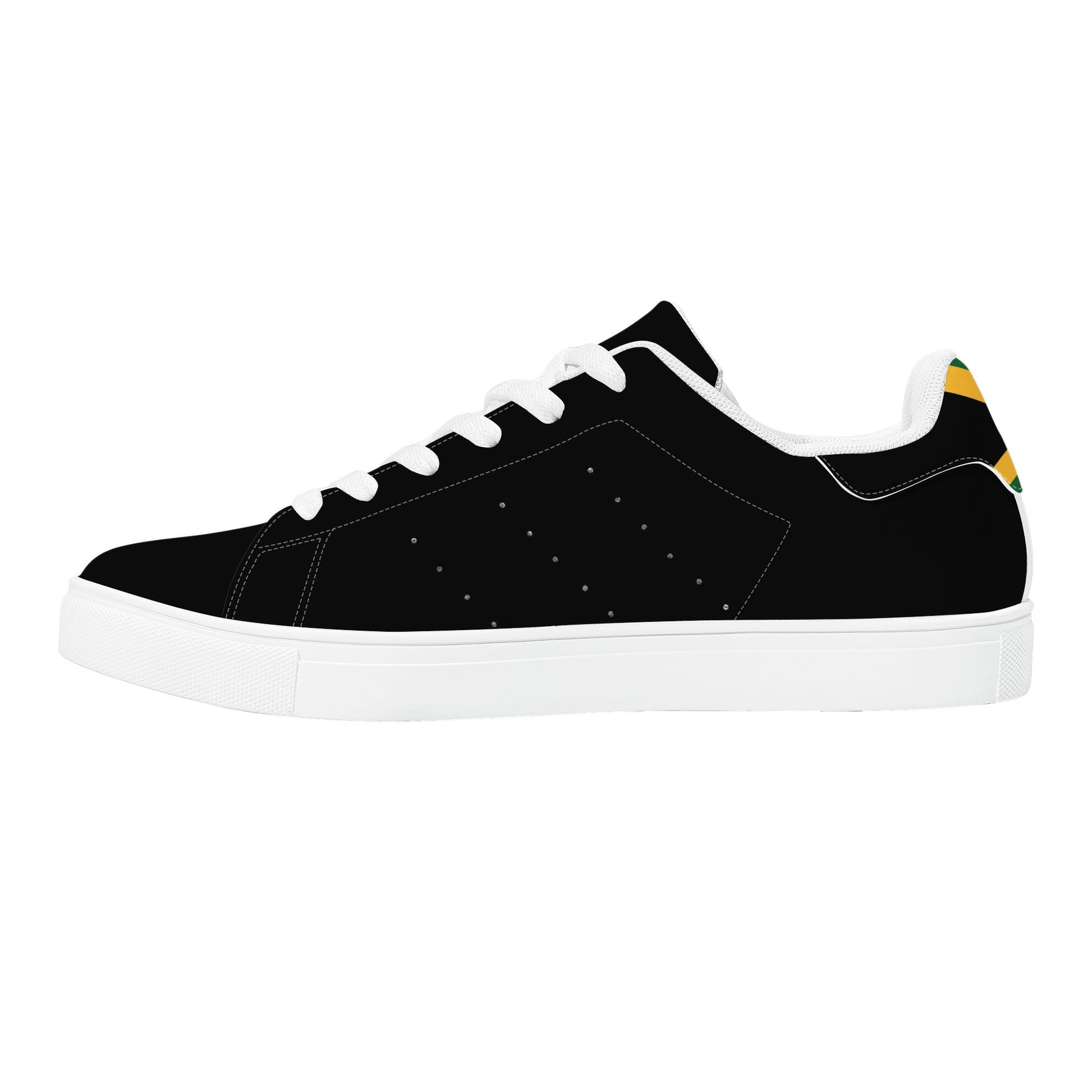 All-black Jamaica flag Ackee Walkers low top sneakers with black laces, black outsole and a green and gold Jamaican flag chevron at the heel