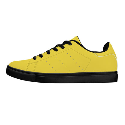 Solid marigold yellow Ackee Walkers low top sneakers, black laces and black outsole