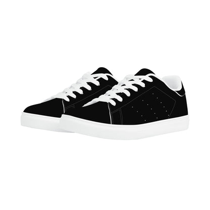 All-black Jamaica flag Ackee Walkers low top sneakers with black laces, black outsole and a green and gold Jamaican flag chevron at the heel