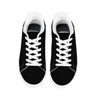 All-black Jamaica flag Ackee Walkers low top sneakers with black laces, black outsole and a green and gold Jamaican flag chevron at the heel