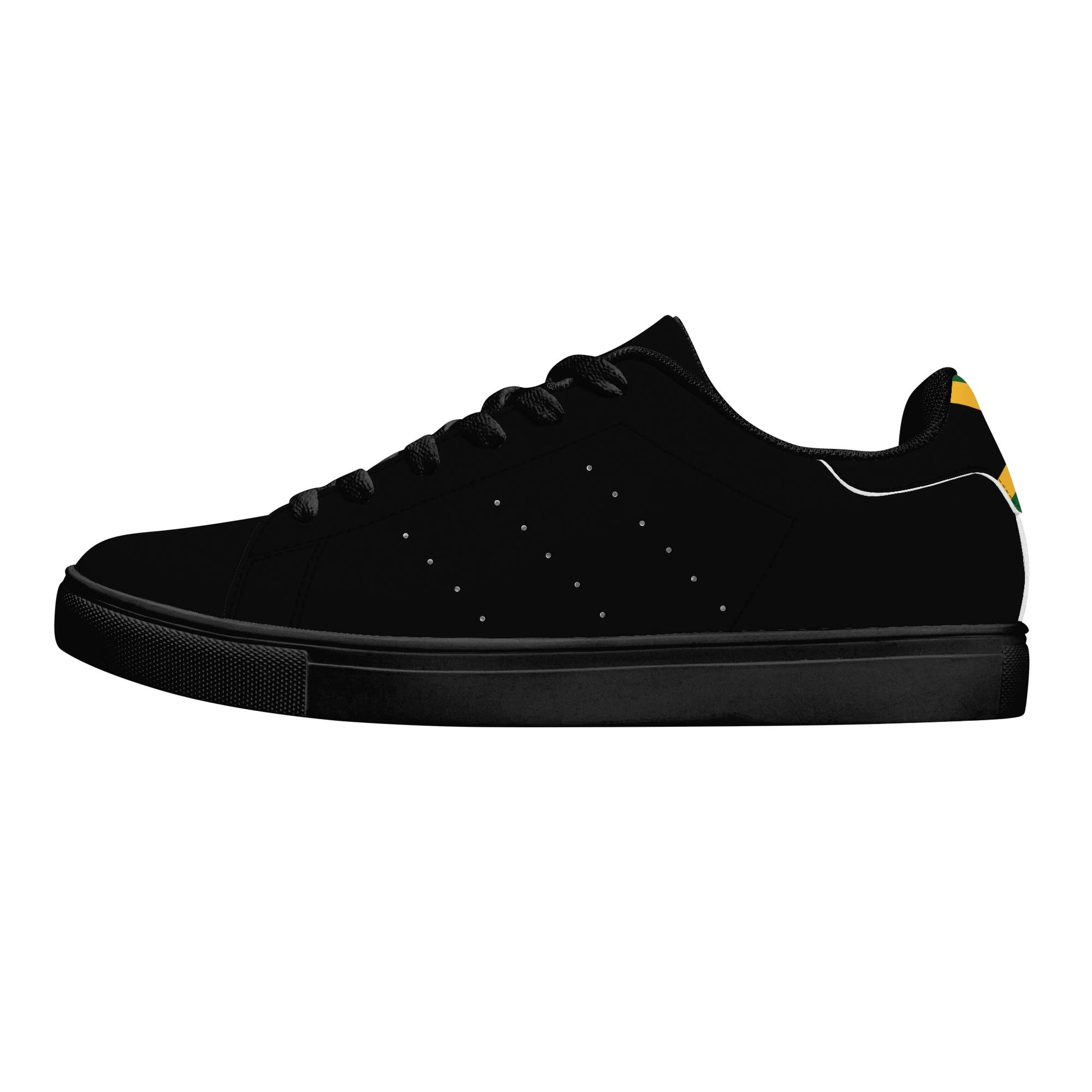 All-black Jamaica flag Ackee Walkers low top sneakers with black laces, black outsole and a green and gold Jamaican flag chevron at the heel