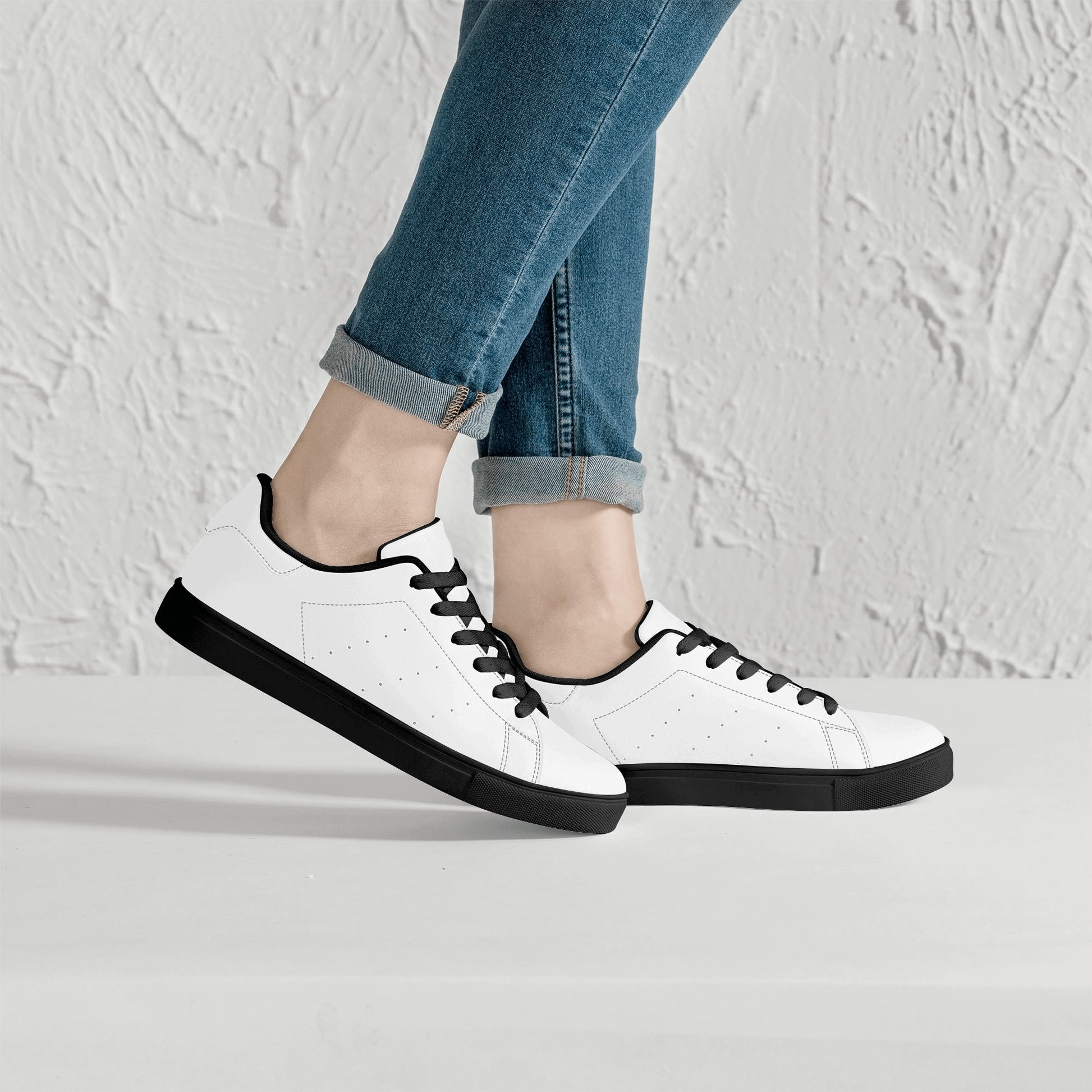 Solid white Ackee Walkers low top sneakers, black laces and black outsole