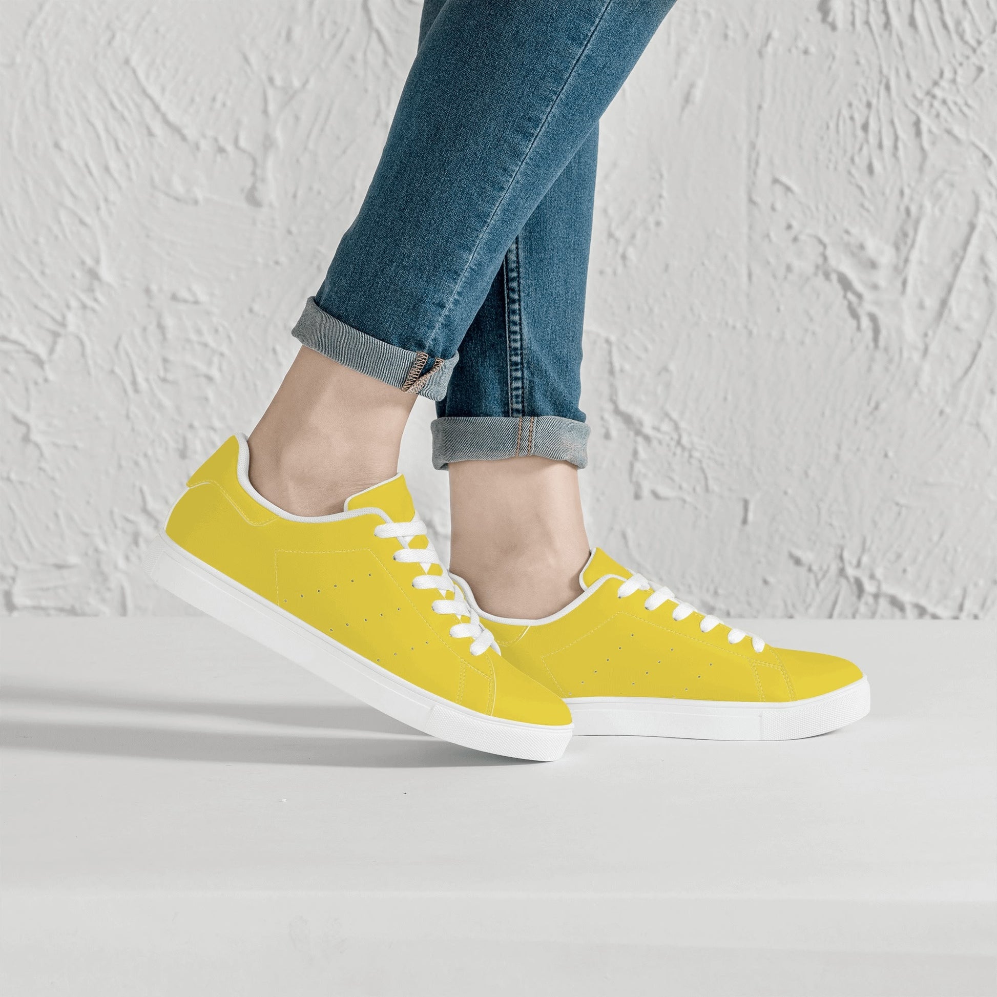 Solid marigold yellow Ackee Walkers low top sneakers, black laces and black outsole