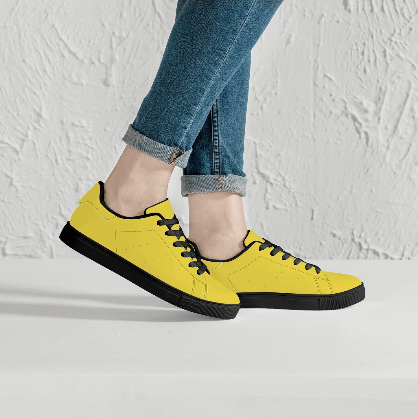 Solid marigold yellow Ackee Walkers low top sneakers, black laces and black outsole