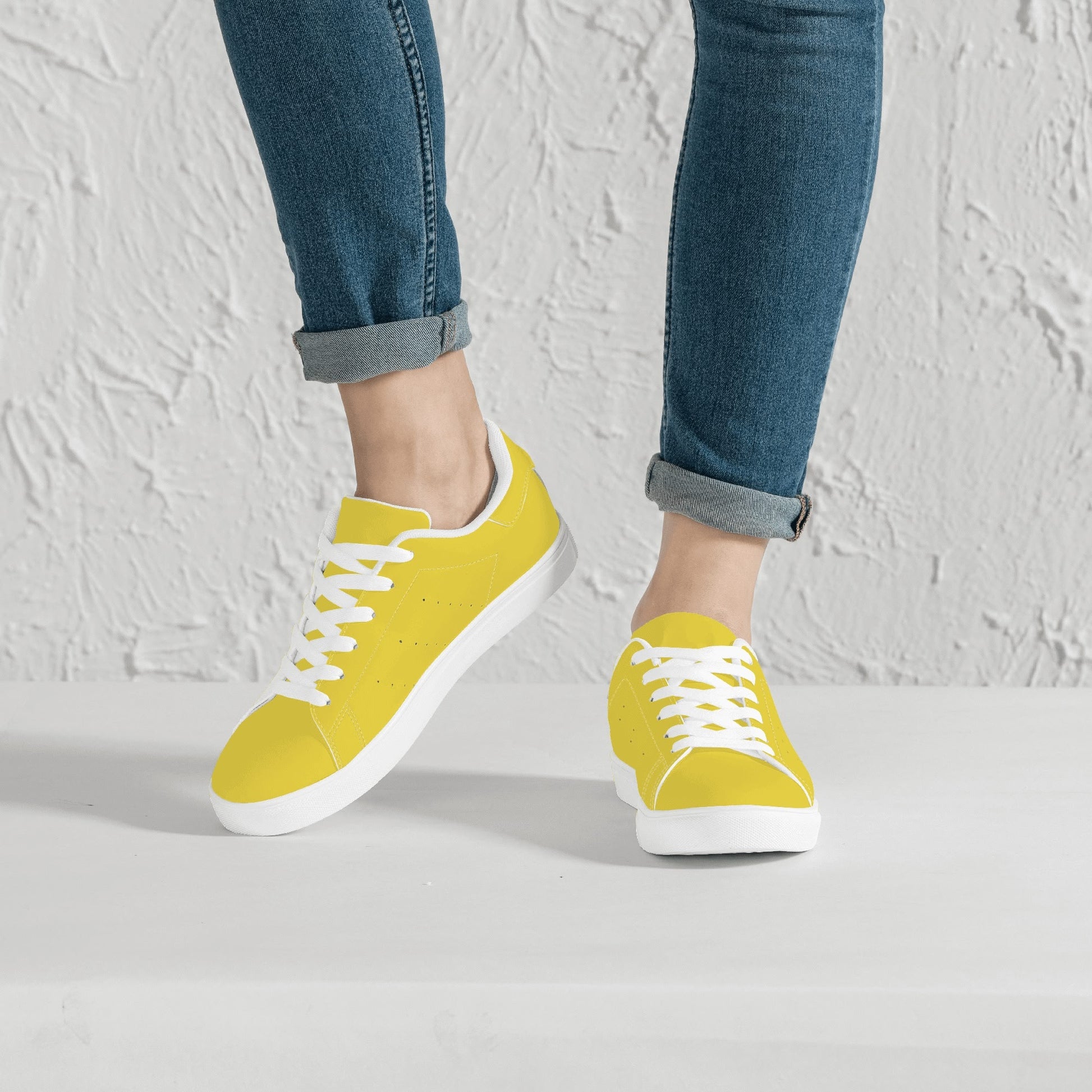 Solid marigold yellow Ackee Walkers low top sneakers, black laces and black outsole