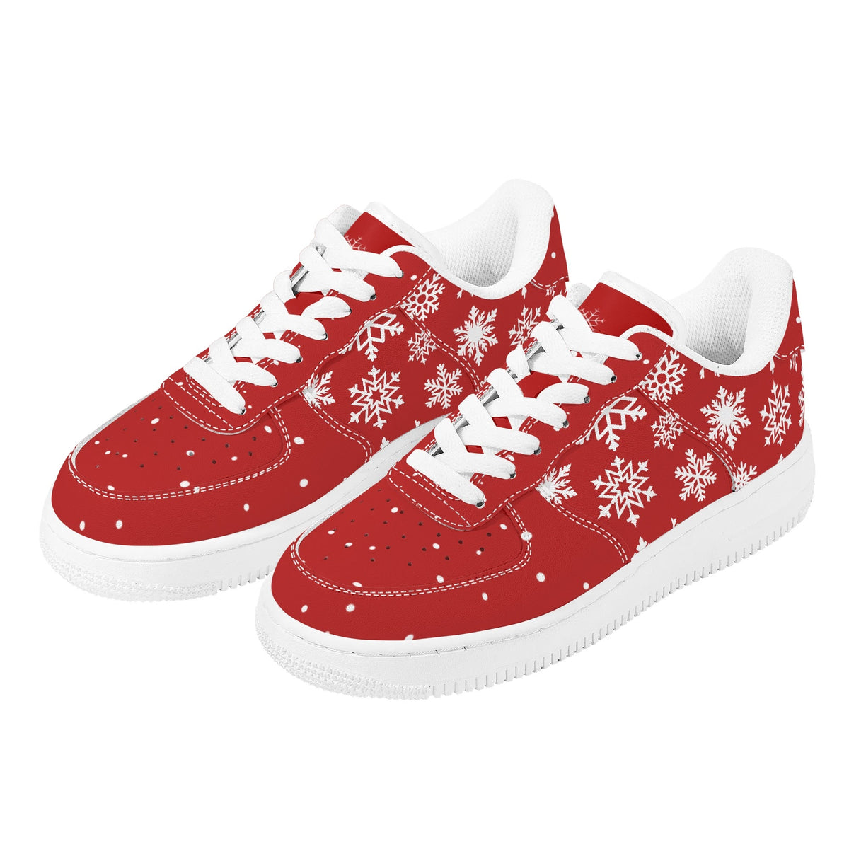 Pair of red Christmas low top sneakers with white snowflakes, white laces and white soles, three-quarter view