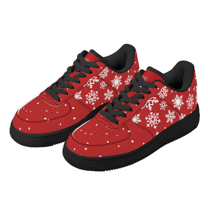 Pair of red Christmas low top sneakers with white snowflakes, black laces and black soles, three-quarter view