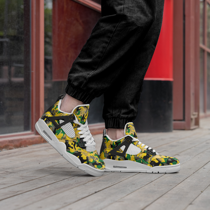 High-top sneakers with Jamaican colors in a camouflage pattern, white laces, air-cushion soles, and a perforated toe, worn with black trousers on a wooden surface."