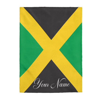 Rectangular Jamaican flag fleece blanket shown flat with white script lettering on the lower panel.